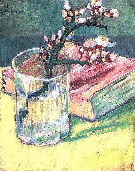 Blossoming Almond Branch in a Glass with a Book